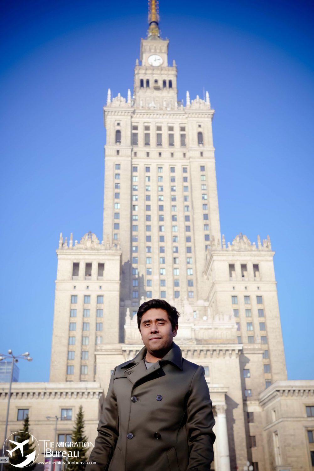 Director of The Migration Bureau in front of palace of Culture and Science. Offering immigration consultations.